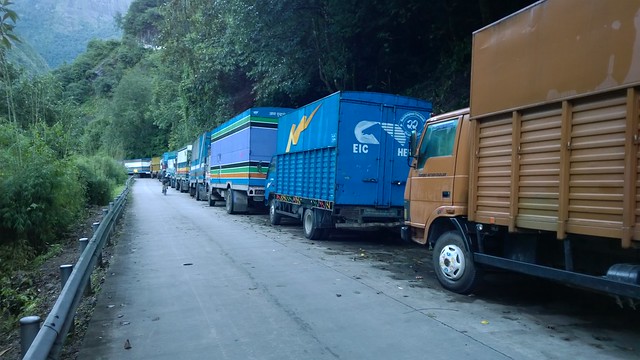 Parked trucks wait to cross the border, Zhangmu